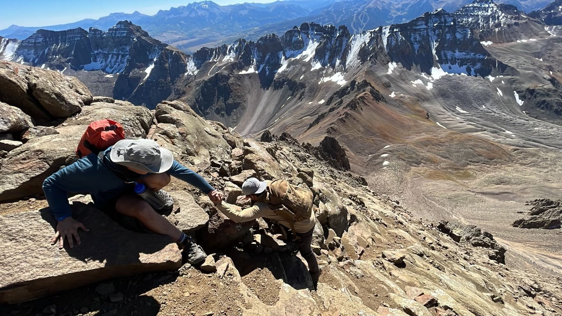 Isaac hoisting Anthony on mountain